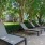 Large pool deck with covered seating and plenty of lounge chairs